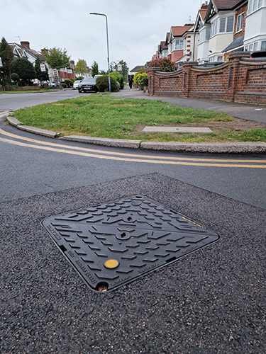 Wrekin Unite manhole cover with an ID badge installed
