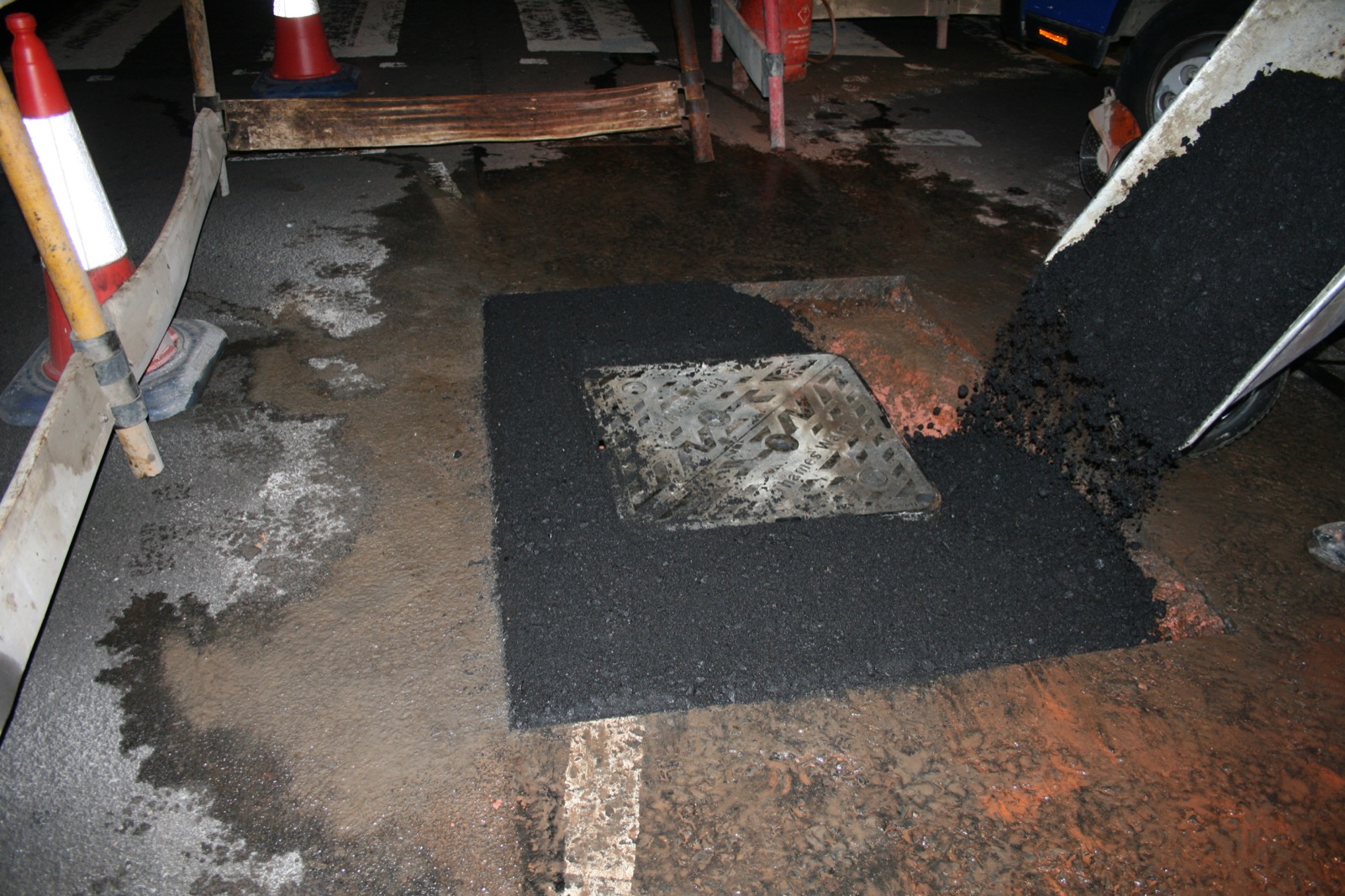 Replacing the tarmac with old cover in place for protection