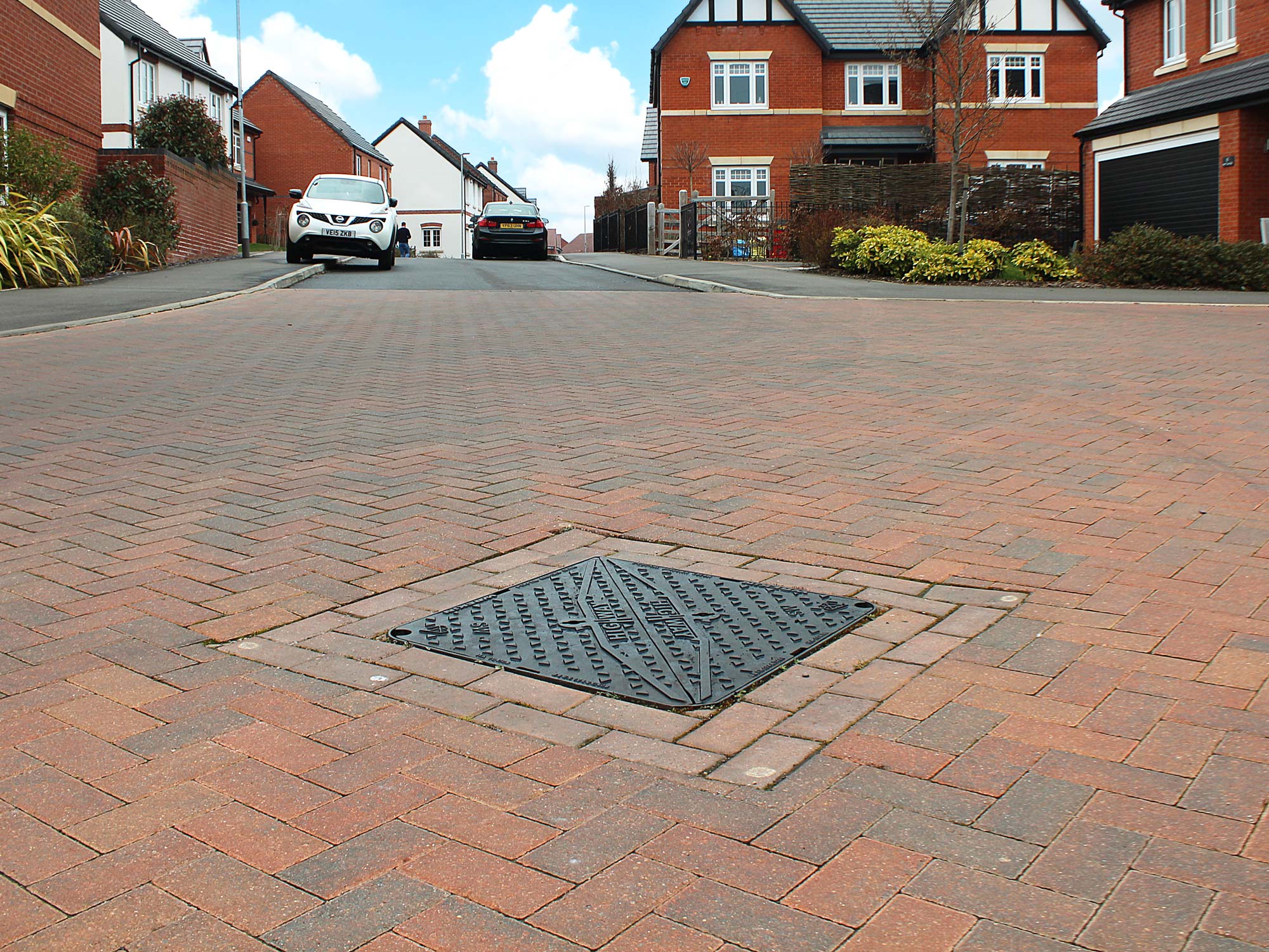 Highway manhole cover installed in road on newbuild housing estate
