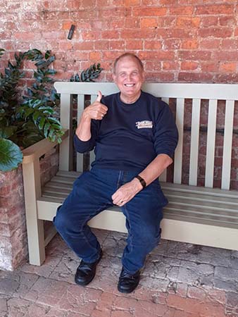 Geoff Turner sitting happily on a bench