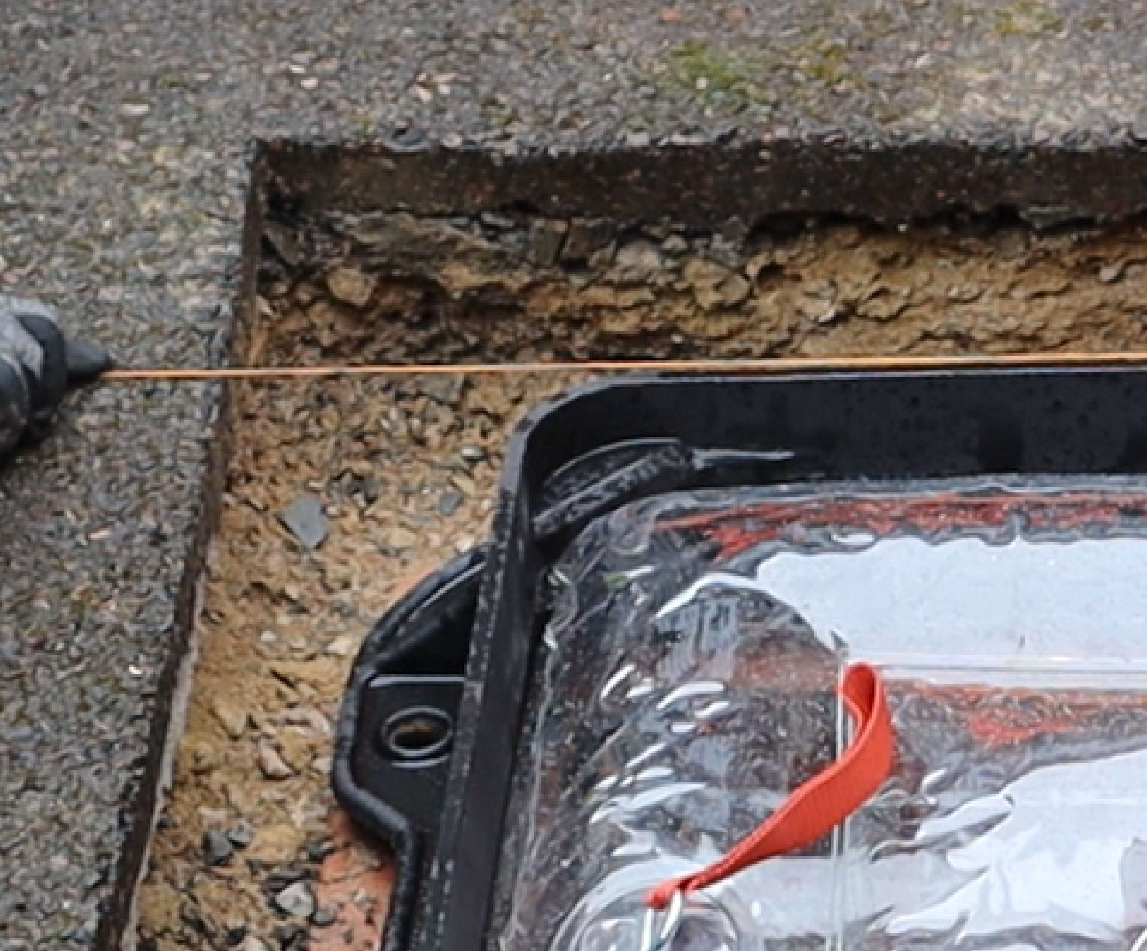 Manhole cover being levelled off with string