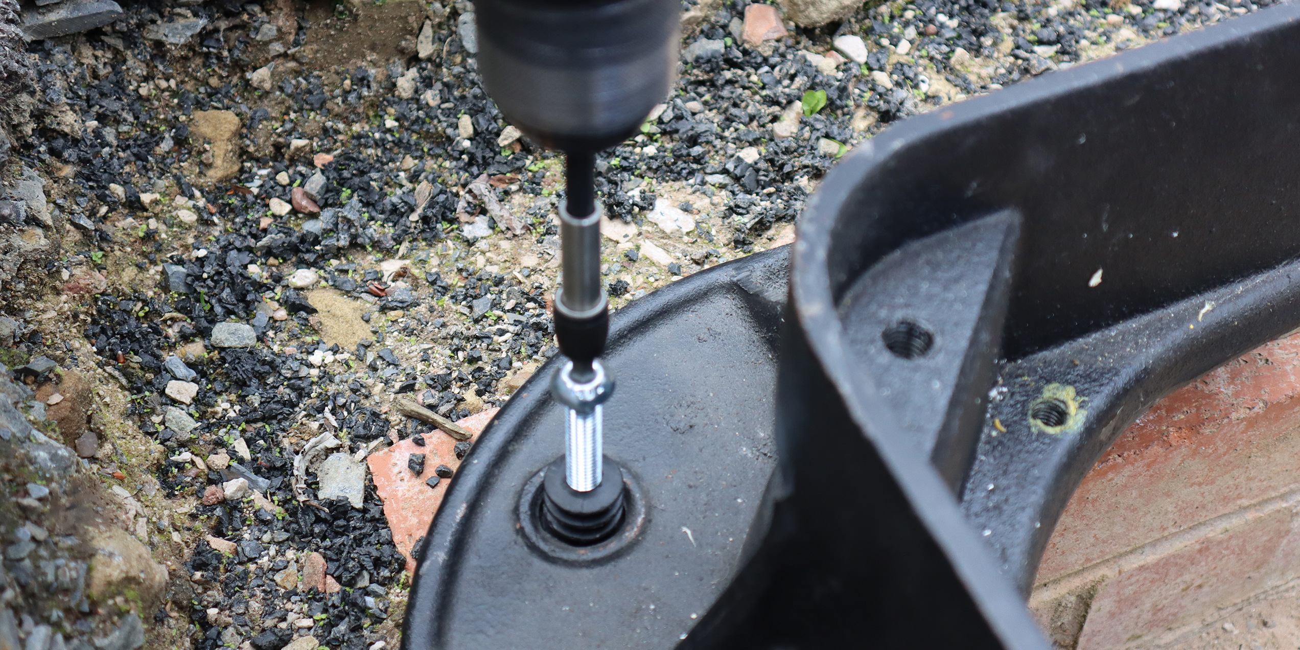 Insert bolt and screw to raise manhole cover frame into position