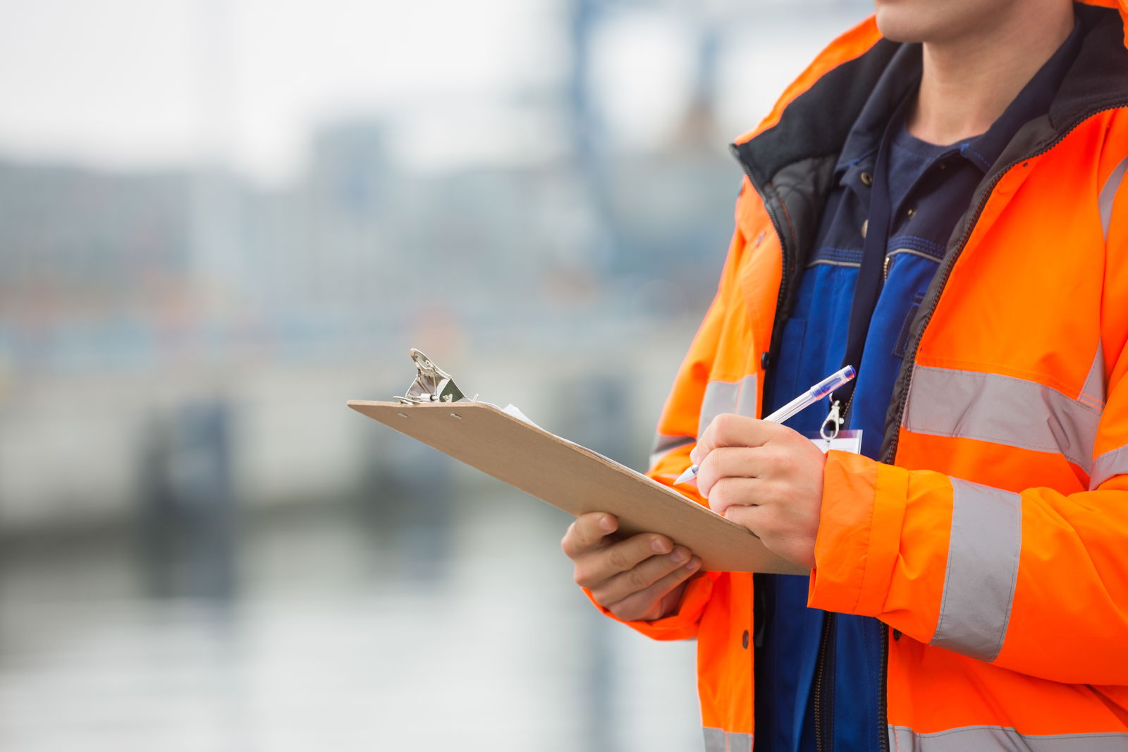 Person holding a clipboard making notes