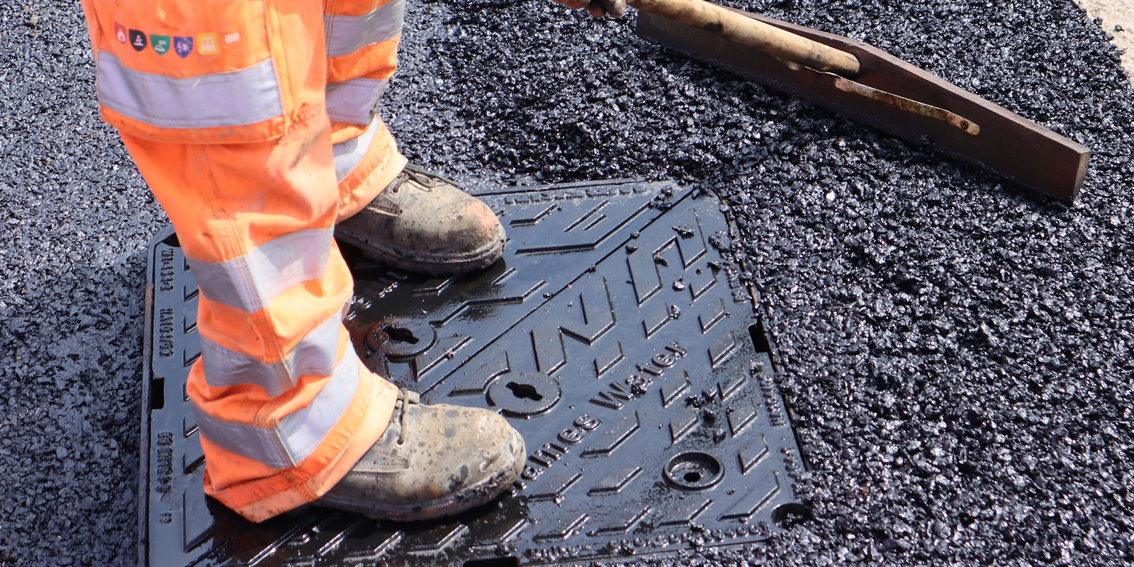 Compacting and adding additional tarmac to match the final road surface