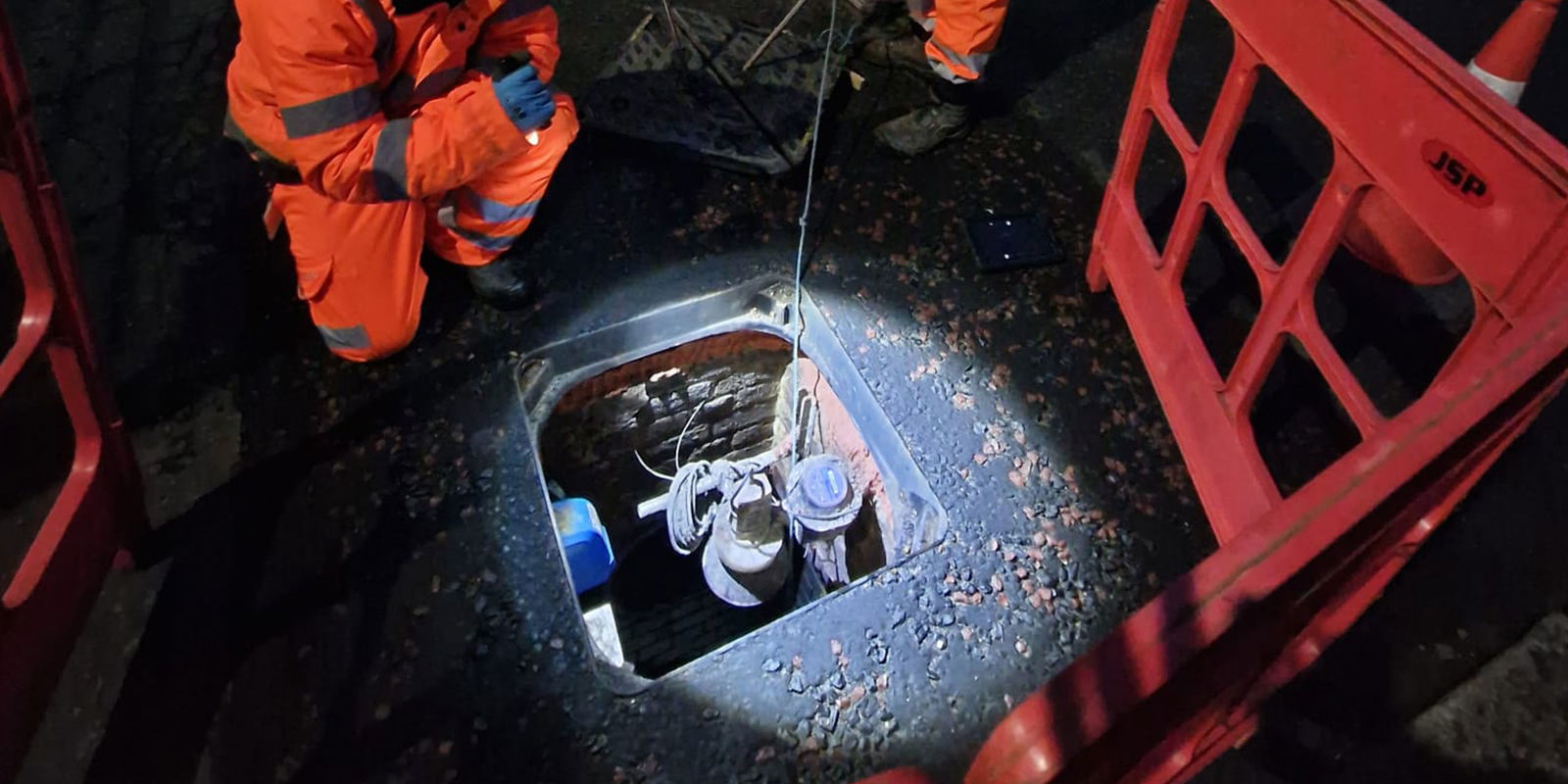 Metering equipment inside a chamber beneath a Wrekin Unite manhole cover