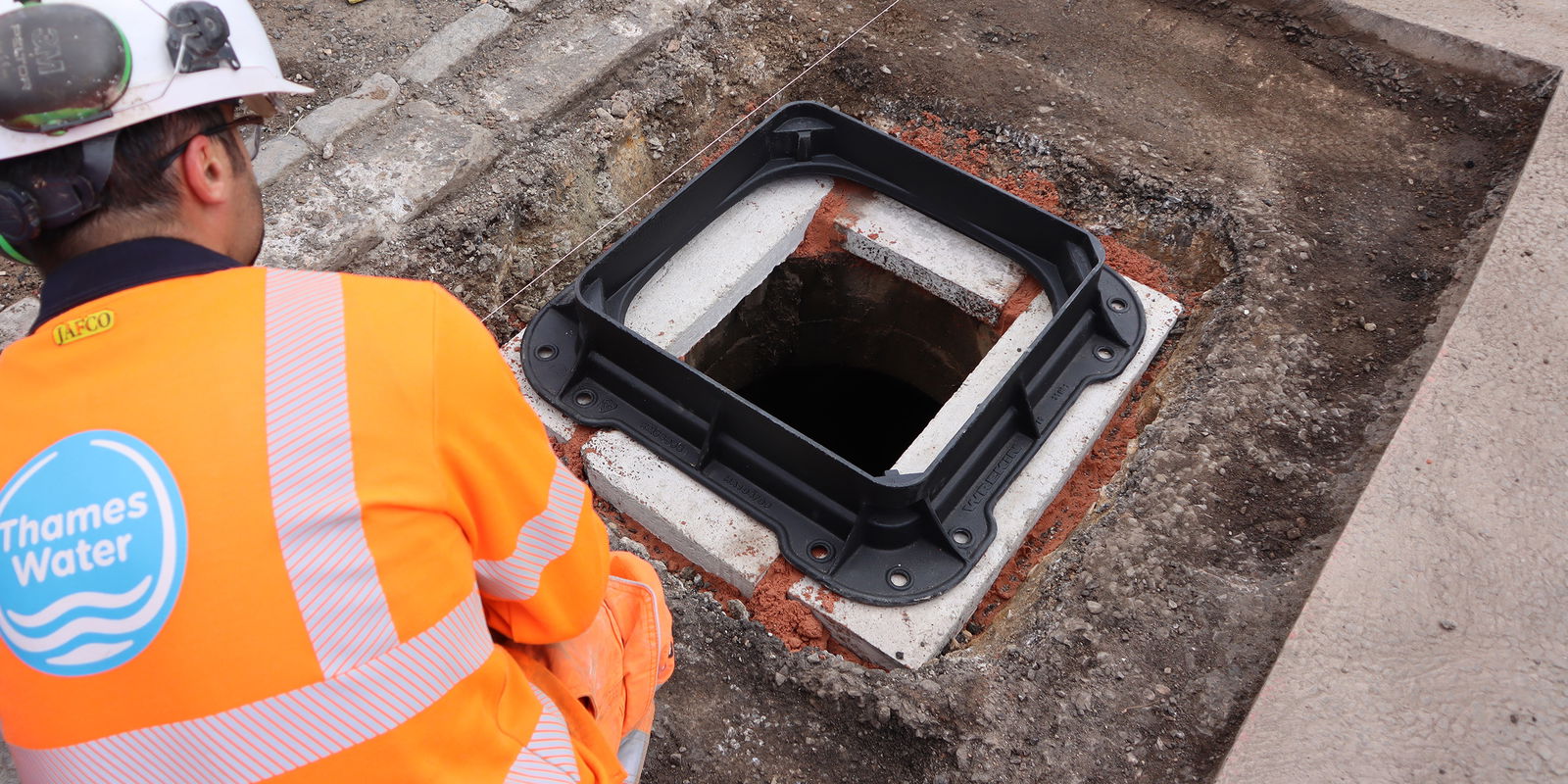Unite manhole cover frame being prepared on a chamber top
