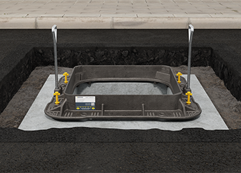 Lifting keys being used to position manhole cover frame