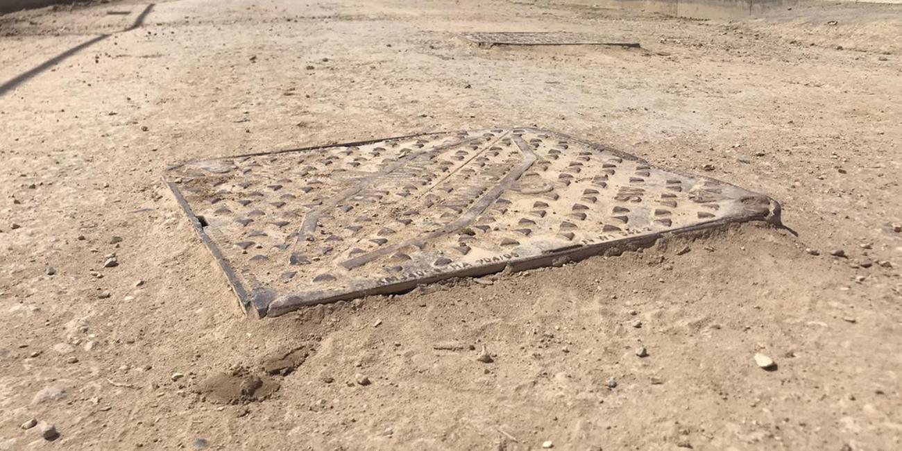 Damaged manhole cover that has been exposed to construction site traffic