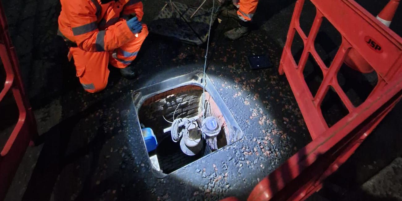 Metering equipment inside a chamber beneath a Wrekin Unite manhole cover