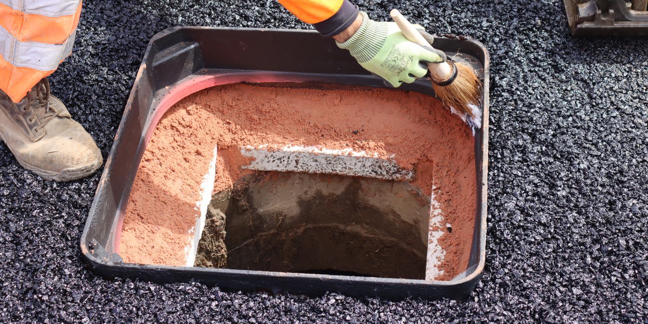 Inside a Unite manhole cover frame showing UniPak bedding mortar