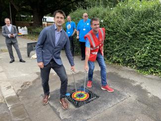 Simon Turner and Martin Cooper install manhole cover in Reading