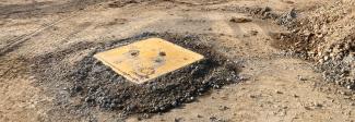 Armadillo manhole cover protector shell installed