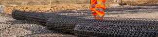 Roll of geosynthetics being laid at Norwich North Recycling Centre