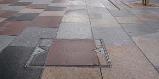 Block filled steel manhole cover installed in pavement