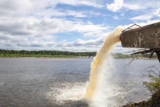 Water flows out of a large pipe