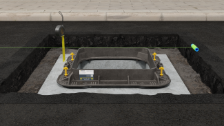 ScrewLift frame raising system in a Unite manhole cover frame showing a string line and tape measure