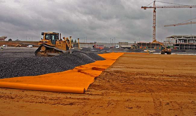 Woven geotextiles being installed on building site
