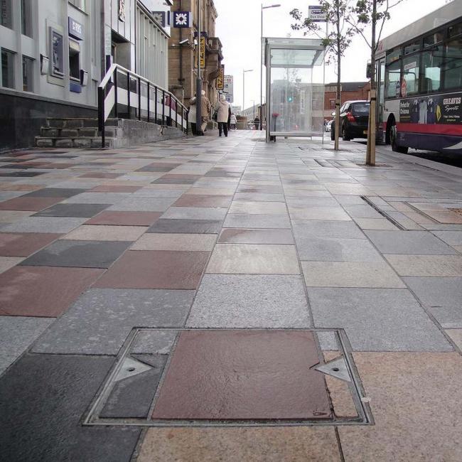 Steel access cover installed in pavement