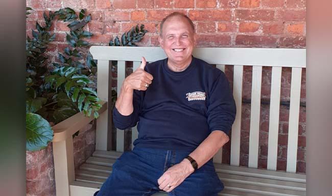 Geoff Turner sitting happily on a bench