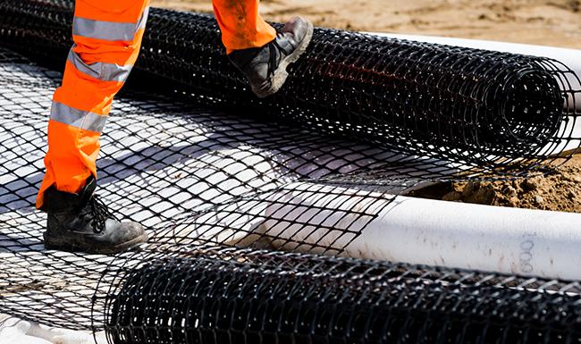 Geosynthetics roll being installed on construction site