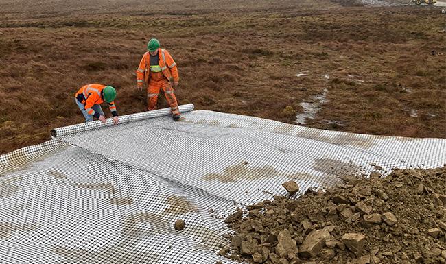 Geocomposite grid and textile being installed