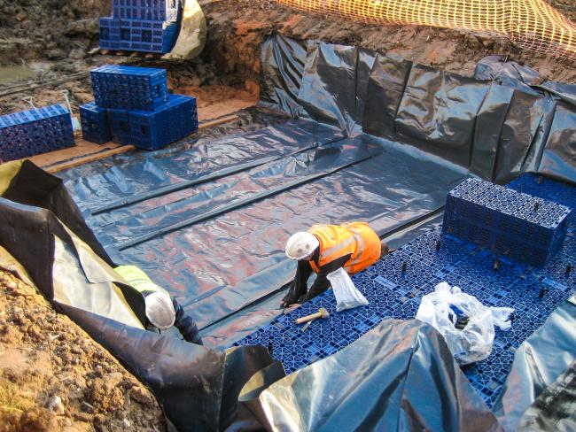 A geomembrane being installed