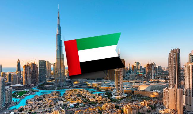 Skyline of Dubai with the United Arab Emirates flag overlayed